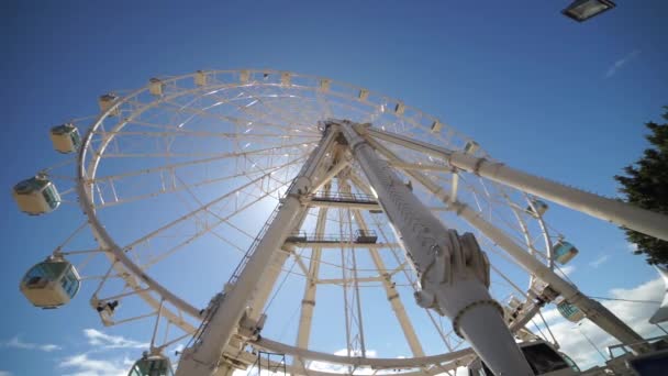 Ferris wheel on sky background in amusement park. Concept of fun, vacation, activity and carnival — Stock Video