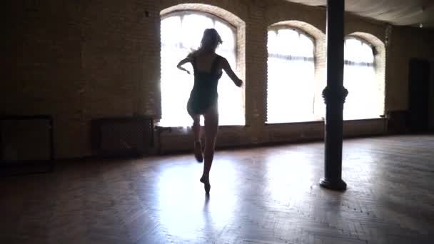 Young, flexible well shaped ballerina dancing with huge windows on background. Concept of healthy and beauty — Stockvideo