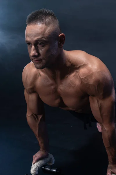 Muscular man doing calisthenic exercise isolated on the black background — Stock Photo, Image