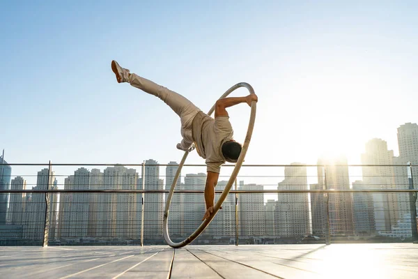 Cyr Wheel artista con fondo de paisaje urbano de Dubai durante la puesta del sol — Foto de Stock