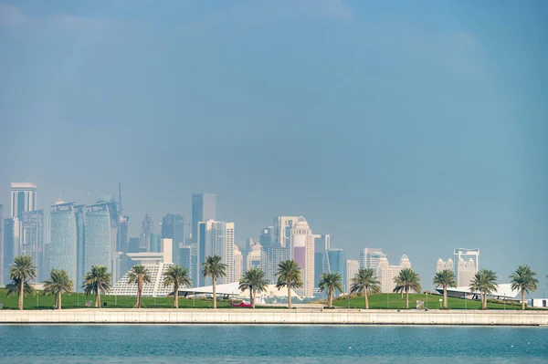 Vista panorámica del horizonte moderno de Doha con palmeras en primer plano. Concepto de medio ambiente saludable — Foto de Stock