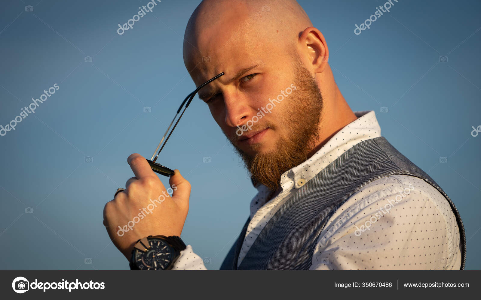 Bald Guy with a stylish beard and sunglasses on a sky background during sunset. Concept of success and will Stock Photo by ©butoc_89@ 350670486 Bald Guy with a stylish beard and sunglasses on a sky background during sunset. Concept of success and will Stock Photo by ©butoc_89@ 350670486
