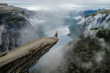 Yog kenarında Trolltunga dua ediyor. Norveç