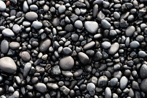 Volcanic rocks on black sand beach, Iceland — Stockfoto
