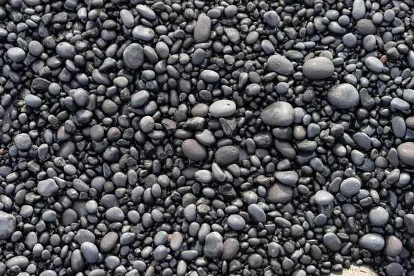 Volcanic rocks on black sand beach, Iceland — Stockfoto