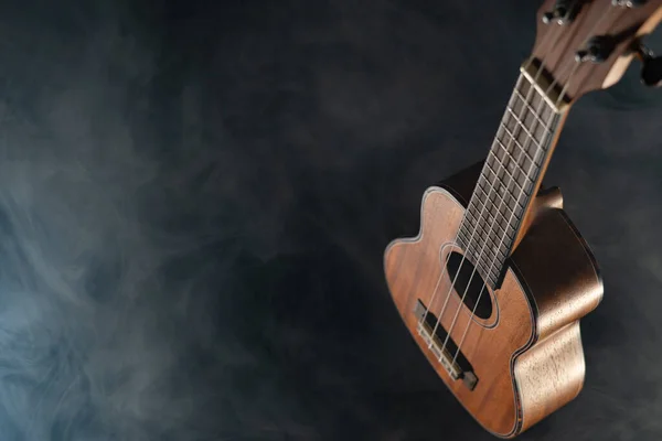 Guitarra ukelele Hawaii aislada sobre fondo negro con humo — Foto de Stock