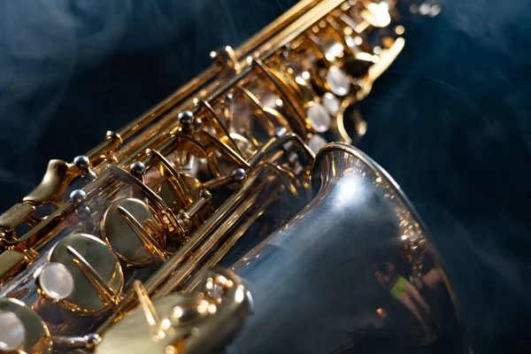 Golden shiny alto saxophone on black background with smoke. copy space — Stock Photo, Image