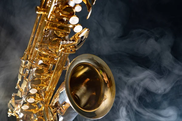 Golden shiny alto saxophone on black background with smoke. copy space — Stock Photo, Image