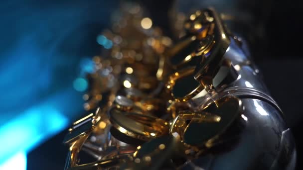 Golden shiny alto saxophone with blue smoke. Concept of muse and creativity — Stock Video