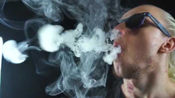 Man blowing many rings of steam and sends it to the camera with in slow motion — Stock Video