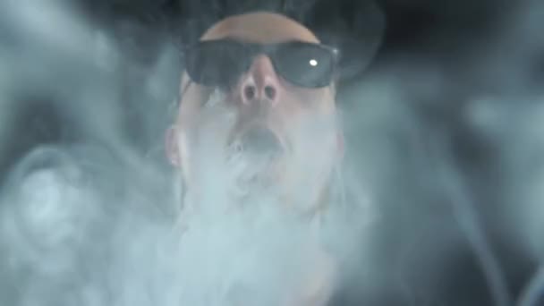 Man vaping big ring of steam and sends it to the camera with in slow motion — Stock Video