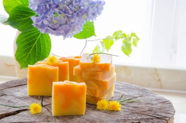 homemade orange and dandelion herbal soap clipart