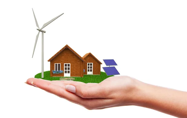 Casa com turbinas eólicas e painéis solares em pé na mão — Fotografia de Stock