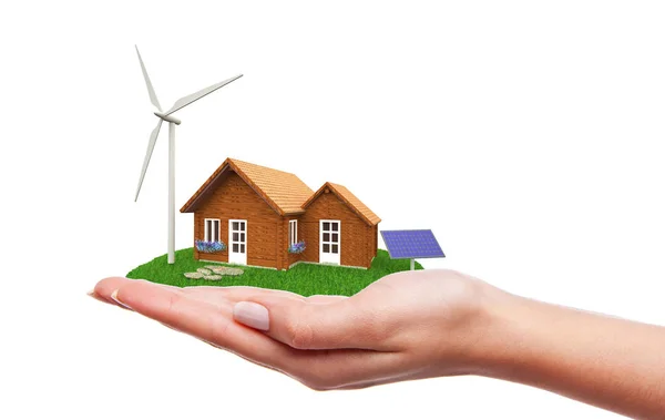 Casa con turbine eoliche e pannelli solari in piedi sulla mano — Foto Stock