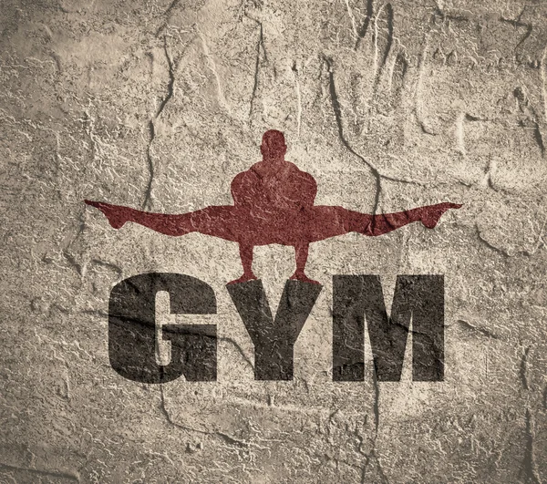 Muskelprotz posiert auf Fitnessstudio-Wort. — Stockfoto