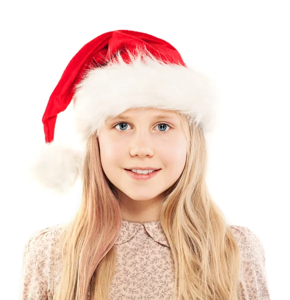 Weihnachtsmädchen mit Weihnachtsmütze lächelt auf Weiß — Stockfoto