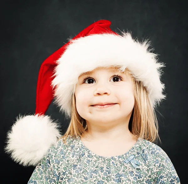 Dziecko Boże Narodzenie. Szczęśliwe dziecko w Santa Hat uśmiechający się Zdjęcia Stockowe bez tantiem