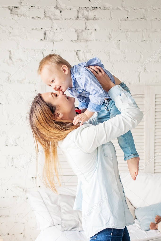 Happy Mother and Son at Home. Mother and Child Hugging.