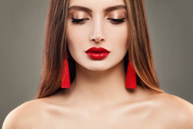 Kırmızı dudaklar makyaj ve takı küpe olan kadın