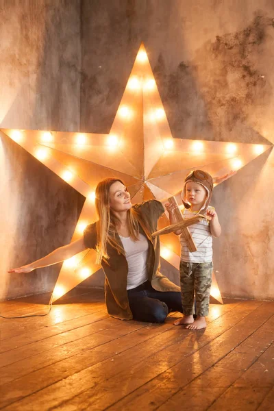 Young Mother and her Child Boy Having Fun with Wooden Plane Toy — Stock Photo, Image