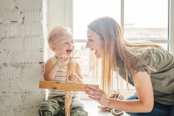 Laughing Mom and Child Boy with Wooden Toys — Stock Photo, Image