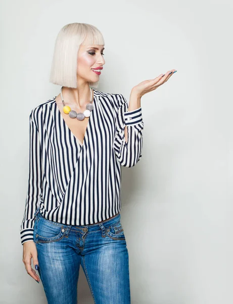 Happy woman showing open hand palm with copy space — Stock Photo, Image