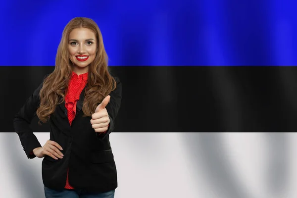 Estonia. Happy girl showing thumb up and smiling on Estonian flag — Stock Photo, Image