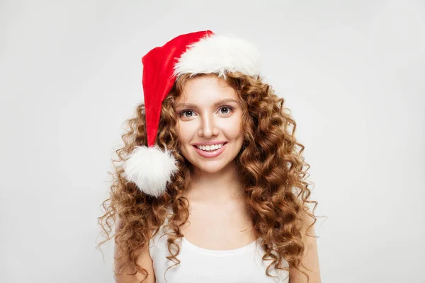 Happy Christmas woman in Santa hat smiling on white background. — Stock Photo, Image