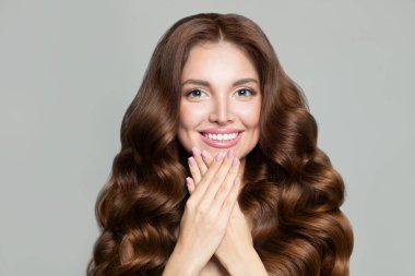 Uzun, sağlıklı, kahverengi kıvırcık saçlı güzel bir kadın. Muhteşem bir model.