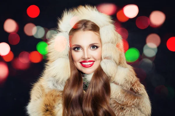 Piękna zima dziewczyna z czerwonymi paznokciami w futrze kaptur z kolorowym bokeh — Zdjęcie stockowe