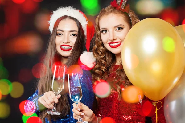 Mulheres alegres de Natal. Duas meninas de moda de inverno no bokeh abstrato — Fotografia de Stock