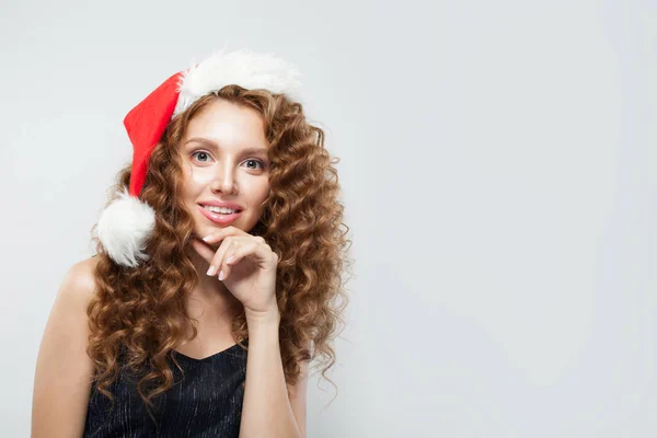 Young woman in Santa hat on white background. — Stock Photo, Image