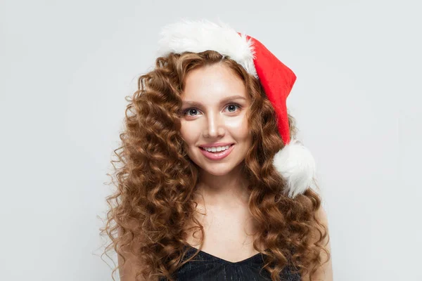 Happy woman in Santa hat smiling on white background. — Stock Photo, Image