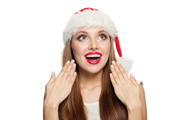 Surprised woman in Santa hat looking up isolated on white — Stock Photo, Image