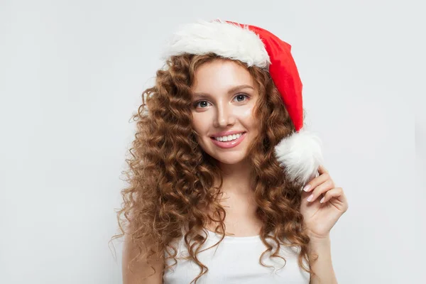 Happy young woman in Santa hat smiling on white background. — Stock Photo, Image