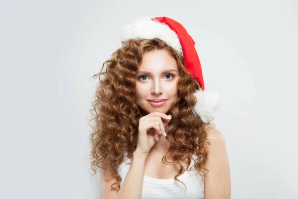 Cheerful pretty model girl in Santa hat on white background. — Stock Photo, Image