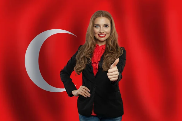 Portrait of happy woman with thumb up on Turkish flag background — Stock Photo, Image