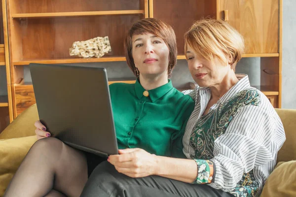Две женщины среднего возраста с ноутбуком в помещении — стоковое фото
