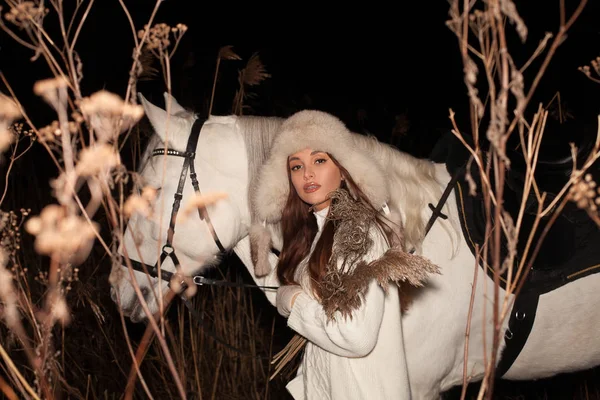 Mulher atraente com cavalo branco à noite — Fotografia de Stock