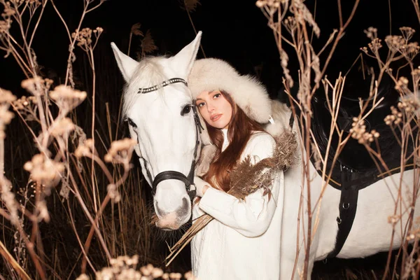 Beautiful woman and white horse, winter evening walk — 스톡 사진