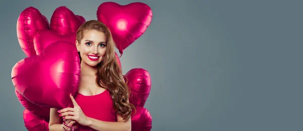 Pink heart balloons and beautiful smiling woman on gray banner — Stock Photo, Image