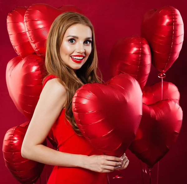 Beautiful model girl with red heart balloons. Surprise, birthday Royalty Free Stock Photos