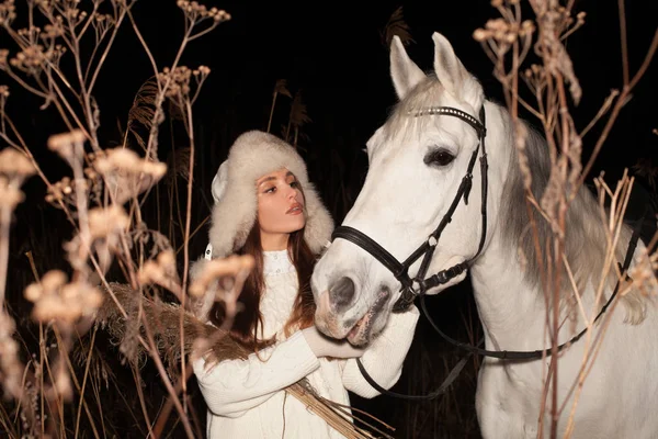 Beautiful young woman with white horse outdoors — 스톡 사진