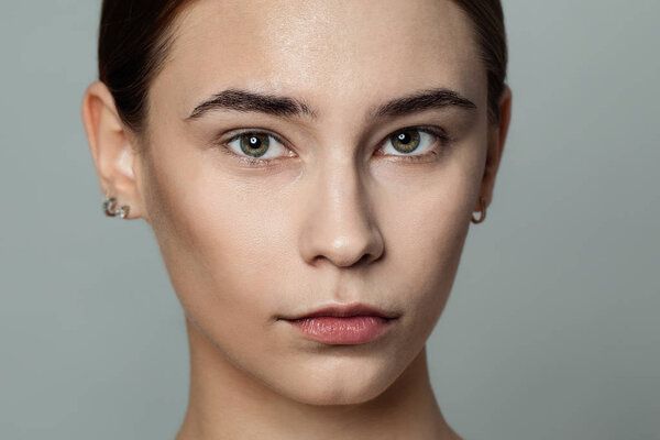 Young beautiful woman without makeup cosmetics portrait.