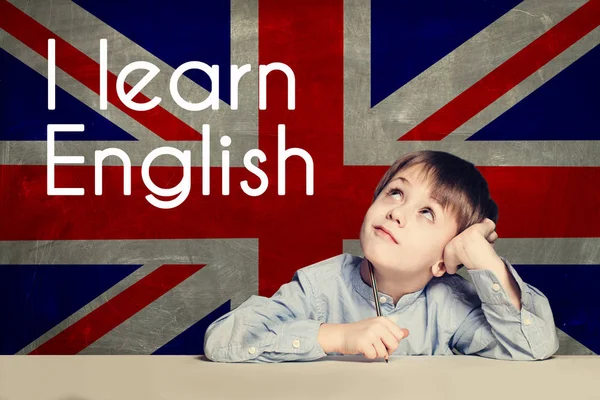 Happy smart child against the Uk flag background. — Stock fotografie