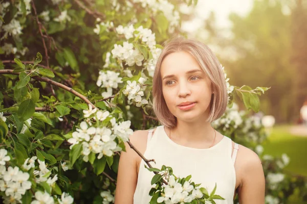 Mujer joven en jardín de flores de primavera —  Fotos de Stock