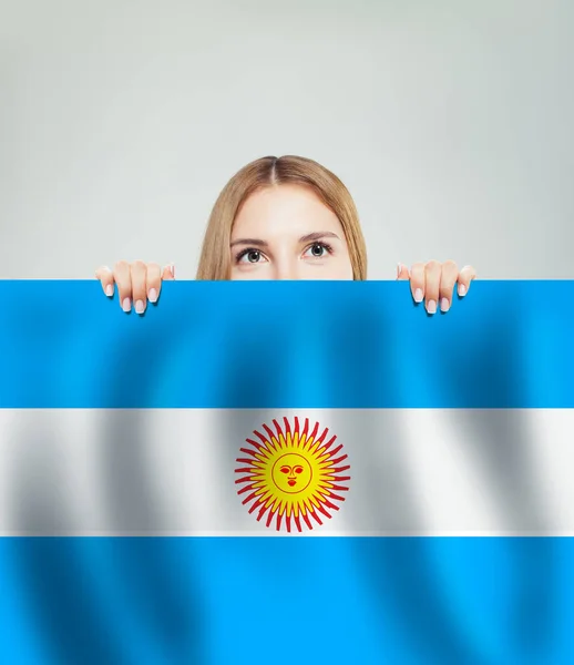 Happy woman student and the Argentina flag background. Travel and learn spanish language