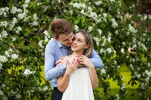 Young couple in spring garden. Romantic vacation