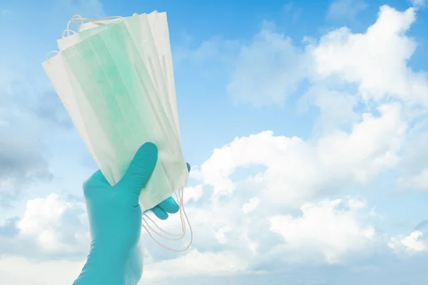 Hand Blue Doctor Gloves Holding Protective Mask Sky Clouds Background — Stock Photo, Image