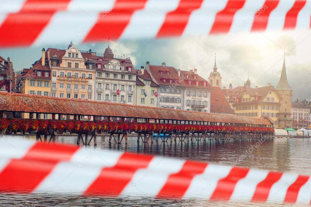 Old bridge across river in Lucerne, Switzerland with warning tape